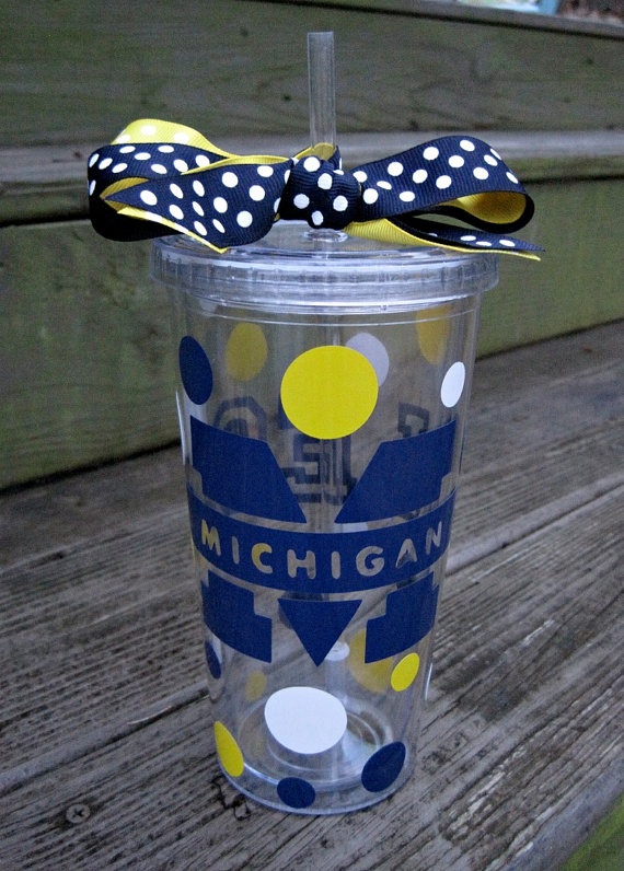 a polka dot cup with a bow on the top and michigan sticker on it