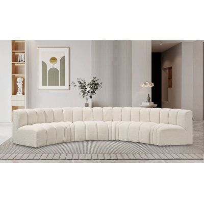 a large white sectional couch sitting on top of a rug