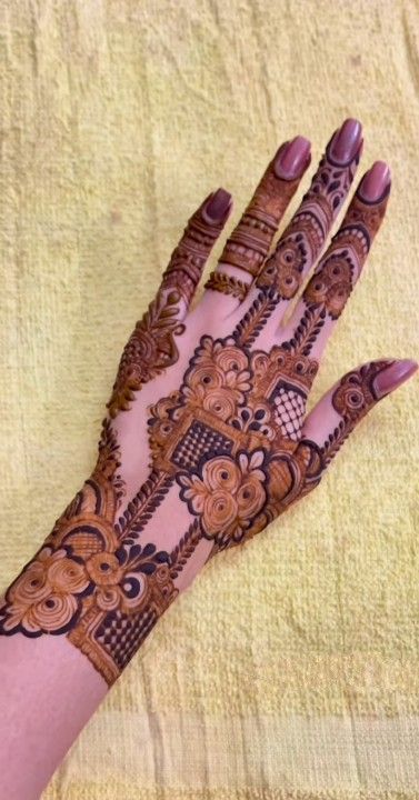 a woman's hand with henna on it