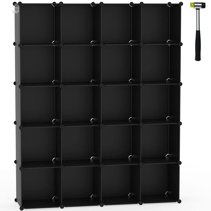 a black bookcase with several compartments and a hammer on the top one is empty