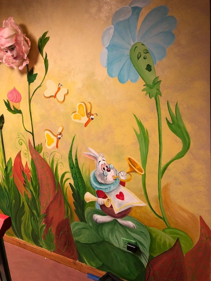 a painting of a rabbit reading a book in front of flowers and butterflies on the wall