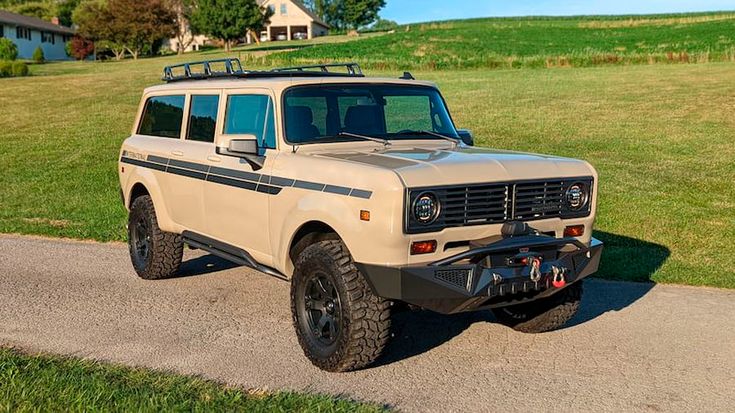 an off - road vehicle is parked in the driveway