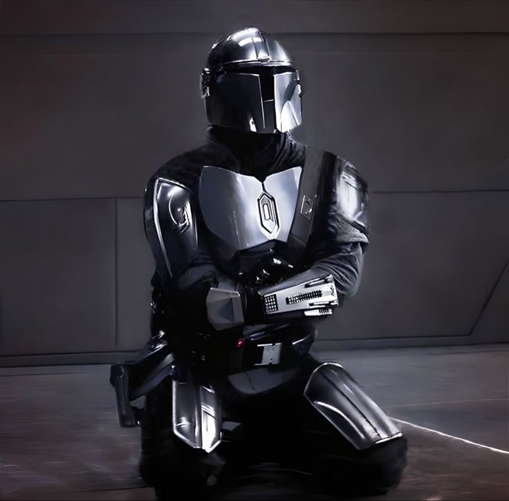 a man in a star wars costume sitting on the ground with his arms folded out