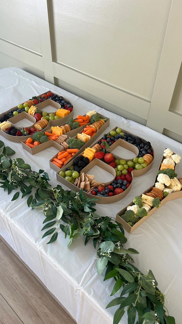 a table topped with fruits and vegetables on top of a white table cloth