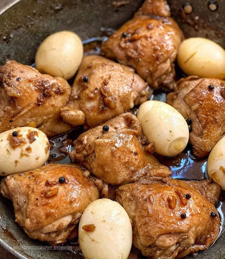 some meat and potatoes are in a pan