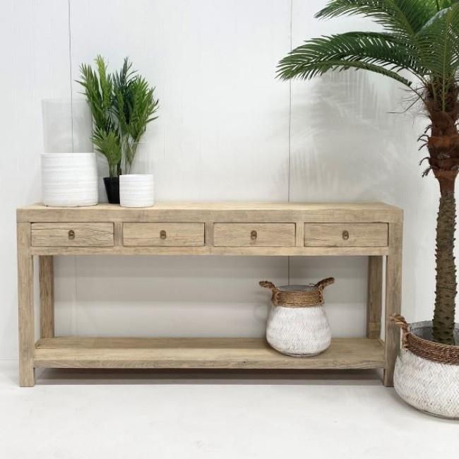 two potted plants sit on top of a wooden shelf next to a planter