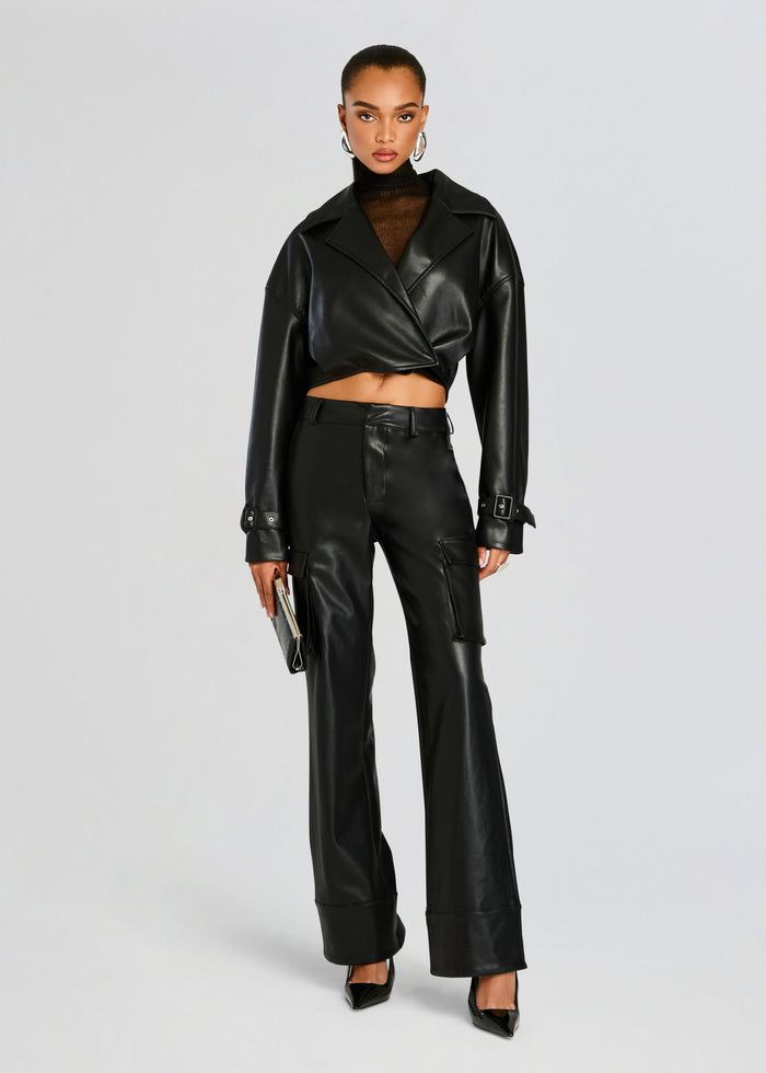 Cropped vegan leather jacket with adjustable buckle cuffs. Shown here in Black. Face: 100% Polyurethane Back: 100% Polyester Made in China Model is 5'10" wearing size S Style No. 4434-19 Jumpsuit And Blazer, Vegan Leather Jacket, Shoes Heels Wedges, Clothing Essentials, Sweater Sale, Romper Dress, Made In China, Active Wear Tops, Skirt Top