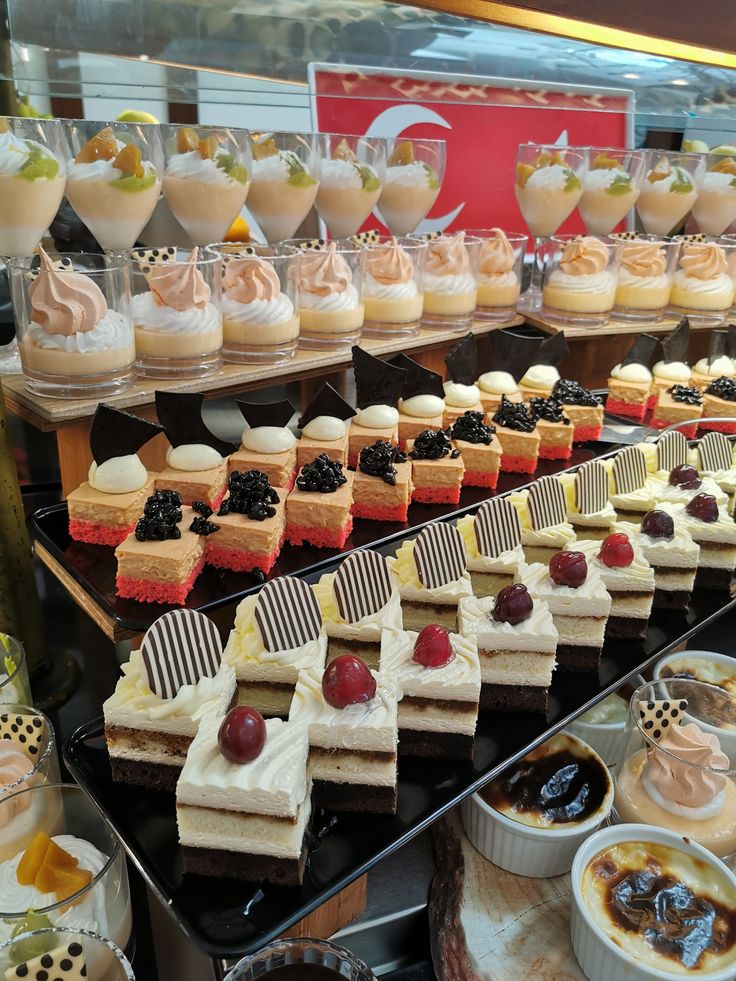 many different desserts are on display for sale