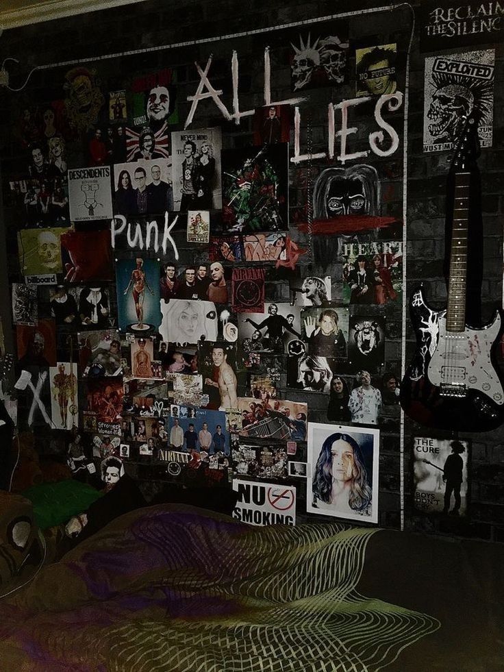 a room with many pictures and guitars on the wall