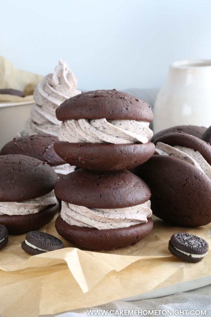 chocolate cookies and ice cream are stacked on top of each other in front of an oreo cookie