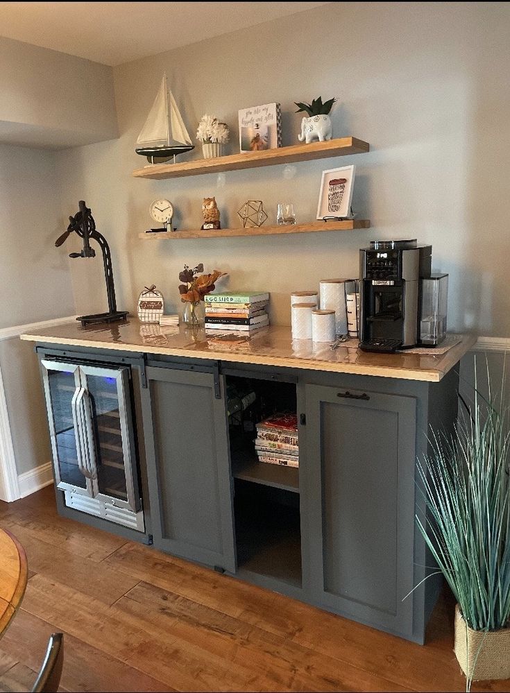 a kitchen area with shelves, cabinets and a potted plant on the counter top