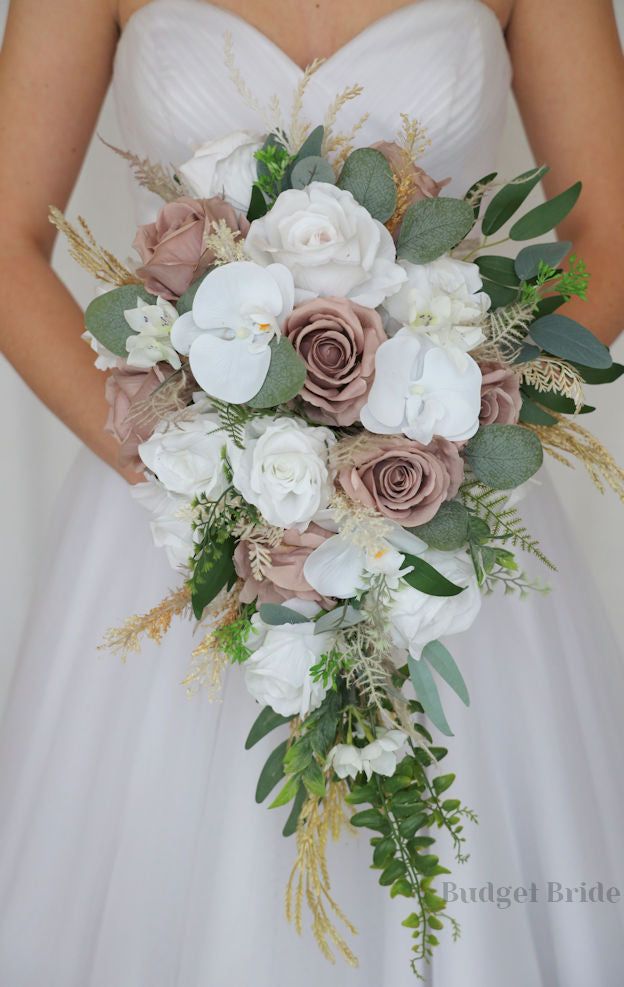 a bridal holding a bouquet of flowers and greenery