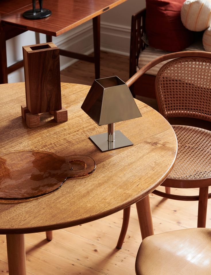 a wooden table with a lamp on top of it