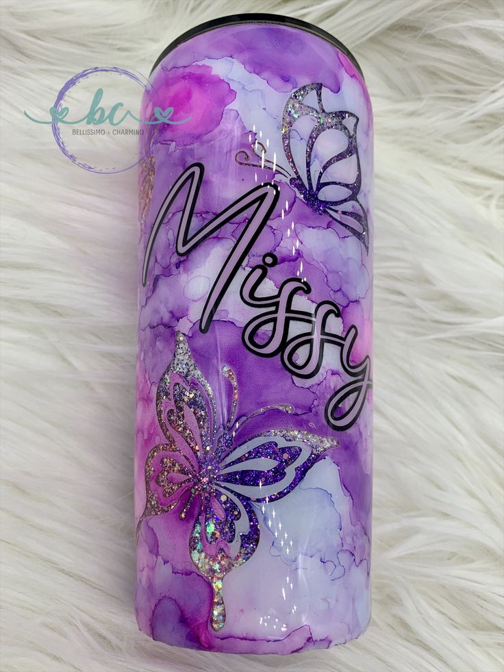 a purple and white canister with butterflies on it that says mesry in black lettering