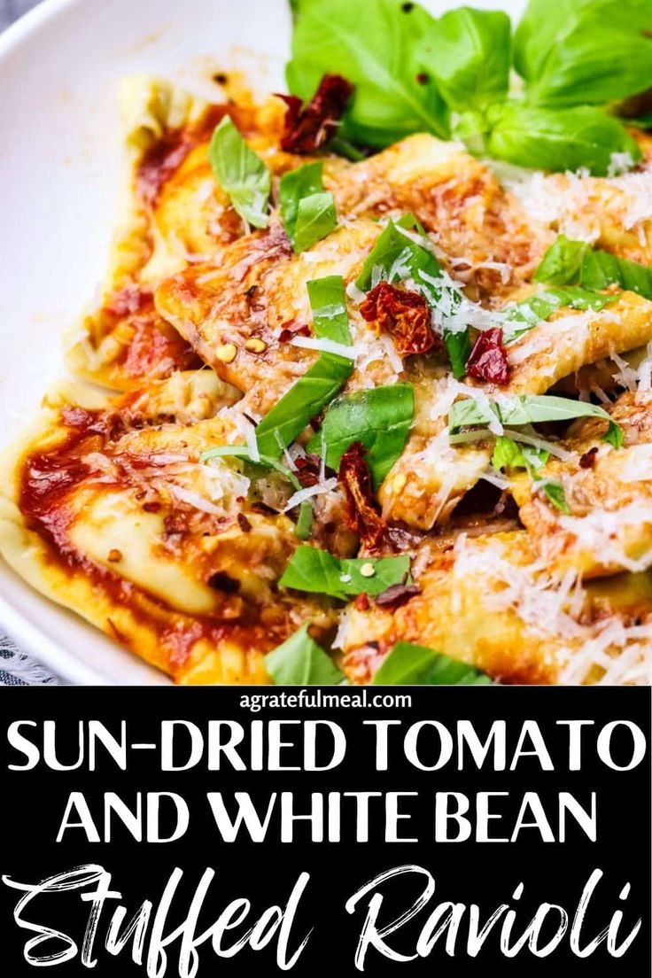 sun dried tomato and white bean stuffed ravioli with spinach leaves in a bowl