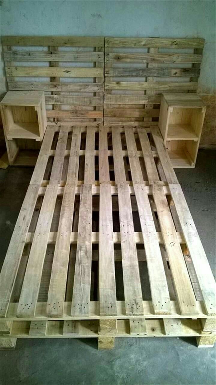 a bed made out of wooden pallets in a room