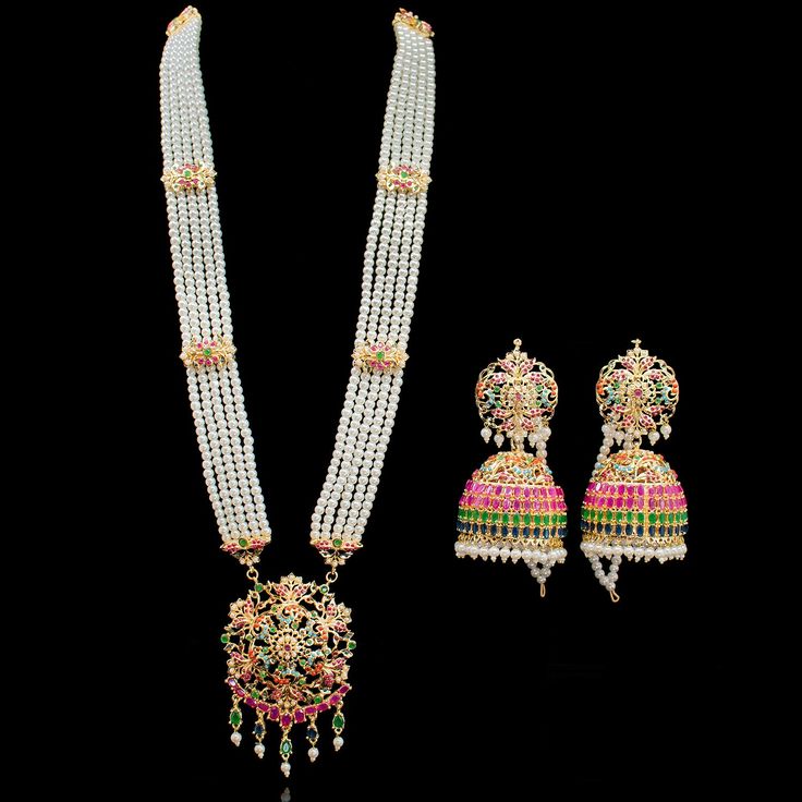 Bringing the heritage of splendour for a classic vogue! A classic and traditional design adorned with beautiful nauratan stones. Approximate earrings length is 4". This set is available in two options: Necklace + Earrings + Teekah Necklace + Earrings Please select the desired option at the time of purchase. This set can be paired with Zehna Nose Ring. Gold-plated on high-quality brass as base metal. Made by order. Kindly allow 4-6 weeks for the delivery of this item. For custom or urgent request Elegant Hand Set Traditional Wear For Diwali, Elegant Multicolor Temple Necklace With Latkans, Traditional White Hand Set Chandbalis, Elegant Ceremonial Jhumkas With Stone Work, White Temple Jewelry Jhumkas For Formal Occasions, Elegant Multicolor Cutdana Jhumkas, Elegant Chandbali Jewelry For Transitional Seasons, Elegant Kundan Traditional Wear With Latkans, Elegant Multicolor Jewelry Sets With Latkans