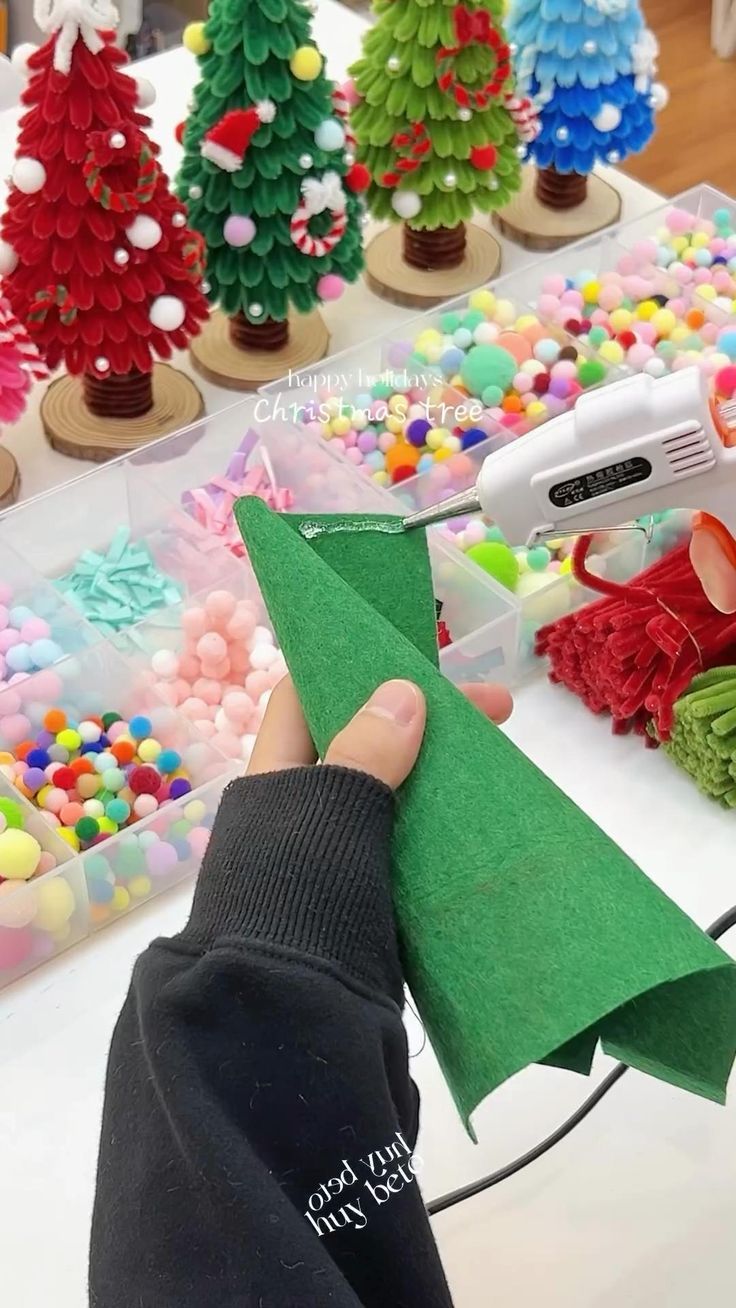 a person is holding a piece of paper in front of some christmas trees and candy