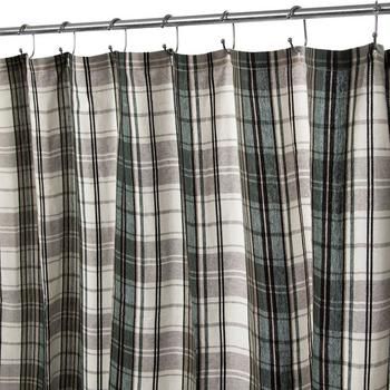 a shower curtain with black and white plaid fabric hanging from it's metal rod