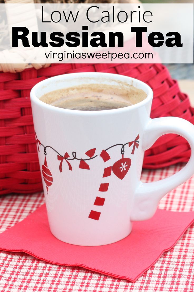 a cup of hot chocolate sitting on top of a red place mat next to a basket