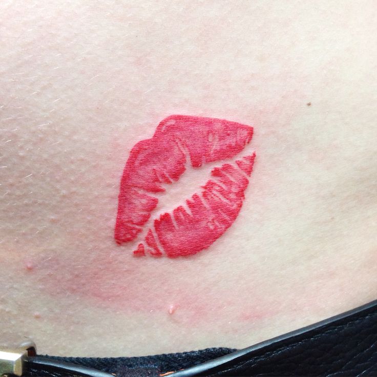 a woman's stomach with a red lipstick imprint on it