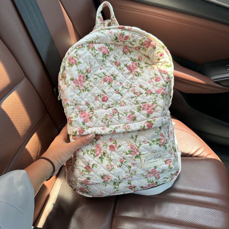 Our Roze Backpack is a charming and stylish bag designed to carry all your essentials with a timeless flair.   The quilted exterior boasts a beautiful floral pattern, complemented by the classy green gingham interior.  Designed for practicality, this backpack features a convenient exterior pocket for easy access to your essentials on the go. Inside, discover another dedicated pocket for added organization, ensuring that your belongings are always at your fingertips.  Ideal for daily commutes, we Quilted On-the-go Standard Backpack, Everyday Quilted Standard Backpack, Quilted Backpack For Back To School, Casual Quilted Backpack For Travel, Casual Quilted Travel Backpack, Casual Quilted School Bag, Quilted Backpack For Travel And Back To School, Quilted On-the-go Backpack, Back To School Travel Backpack With Quilted Detail