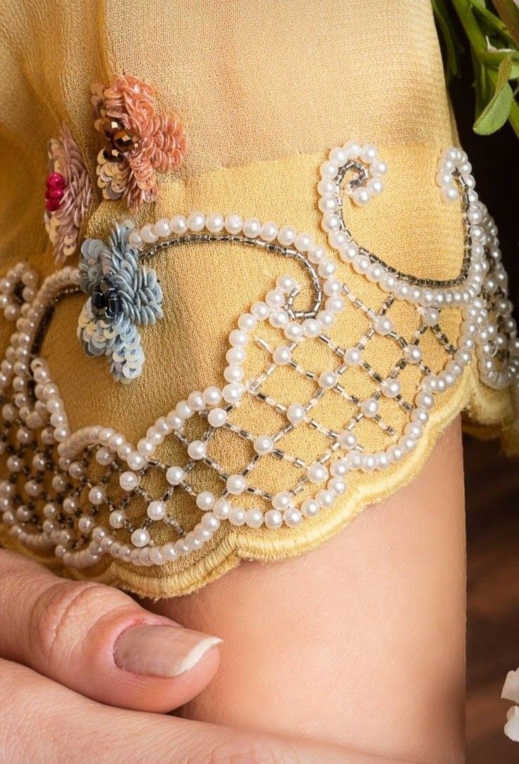 a woman's belly with pearls and flowers on it