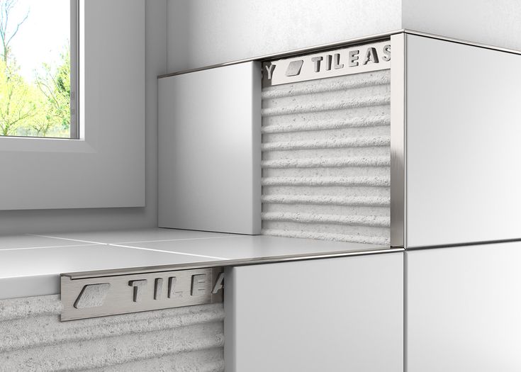 the corner of a kitchen with two refrigerators