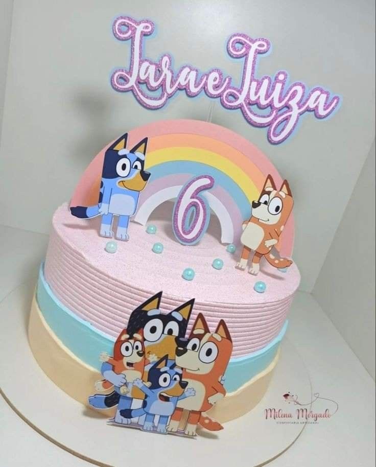 an image of a birthday cake with cartoon characters on it and the number six in the middle