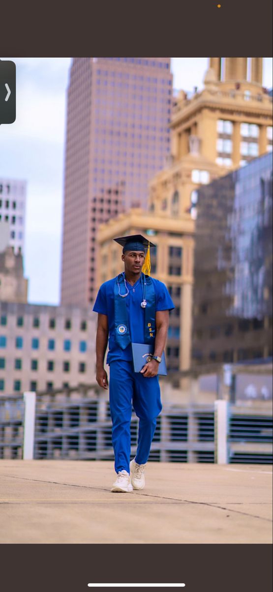 a man in blue is walking down the street