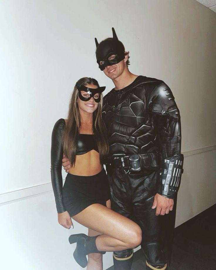 a man and woman dressed up as batman and catwoman pose for a photo together