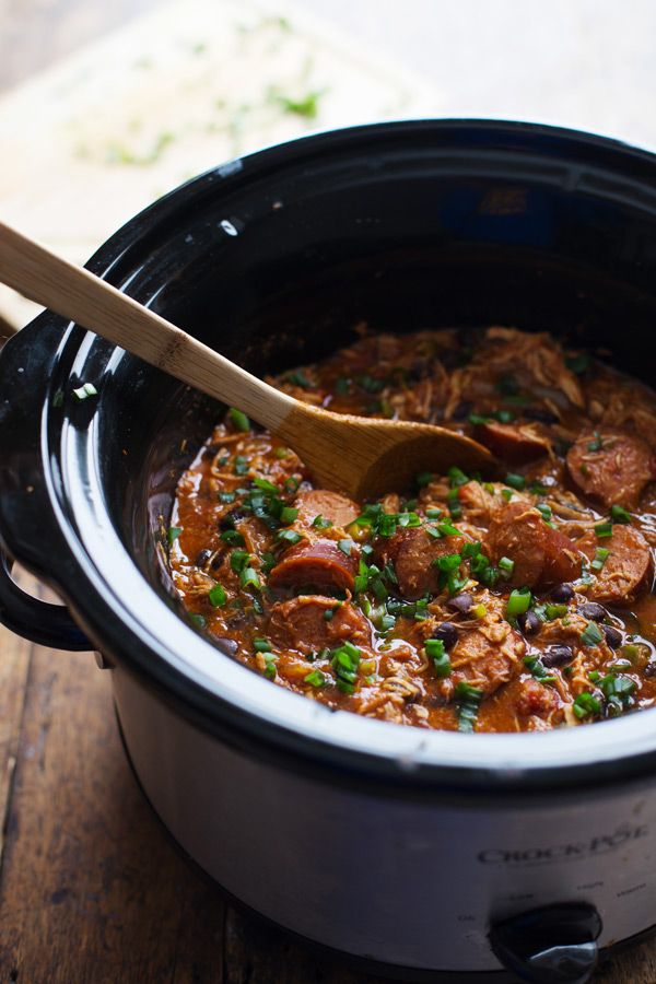 slow cooker crock pot filled with chicken and sausage