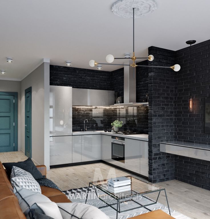 a living room filled with furniture next to a kitchen