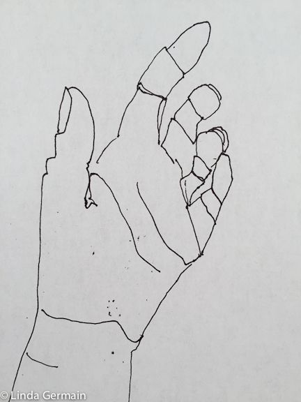 a black and white drawing of a hand holding something in it's left hand