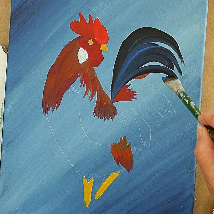 a person is painting a rooster on a canvas