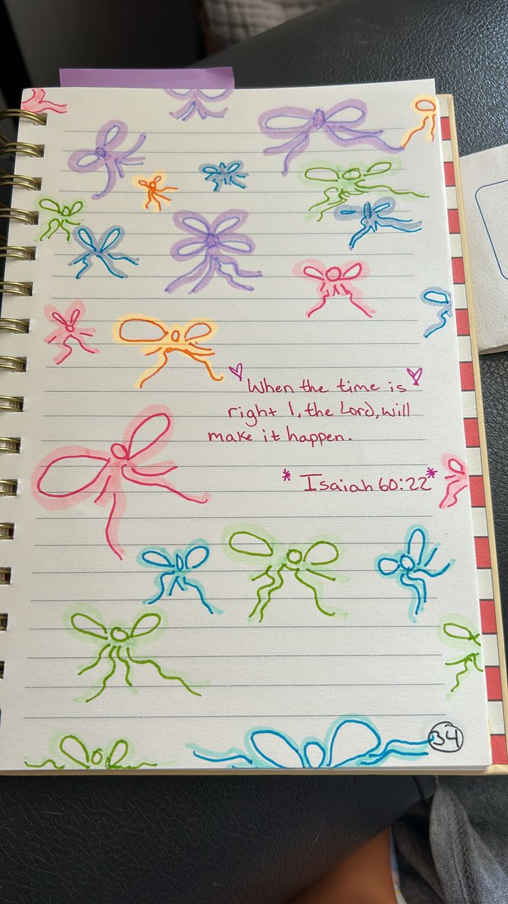 an open notebook with colored bows on it