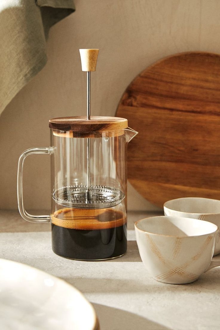 a glass coffee maker sitting on top of a counter