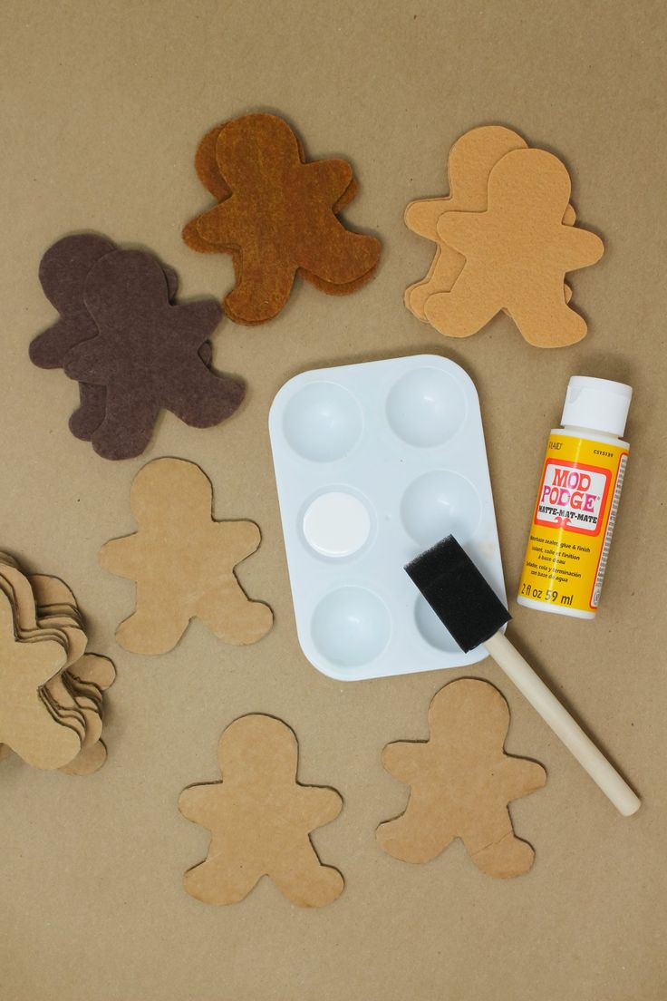 gingerbread cutouts and paint sitting on top of a table