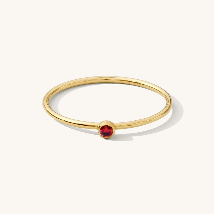 Our dainty January Birthstone Ring features a garnet-colored cubic zirconia, which is January’s birthstone. Garnets symbolize trust, strength, and courage. This dainty stacking ring is a versatile everyday favorite. Its delicate design adds a subtle polish to any outfit. Express your confidence and strength with this dainty ring! DETAILS 14k gold filled ring 1mm band with 2mm garnet-colored cubic zirconia Available in sizes 5-10 Safe for sensitive skin & shower safe Matching jewelry: January Bir Garnet Birthstone Rings, Birthstone Stacking Rings, July Birthstone Ring, January Birthstone Rings, Garnet Birthstone, Dainty Initial Necklace, Multiple Rings, Garnet And Gold, January Birthstone