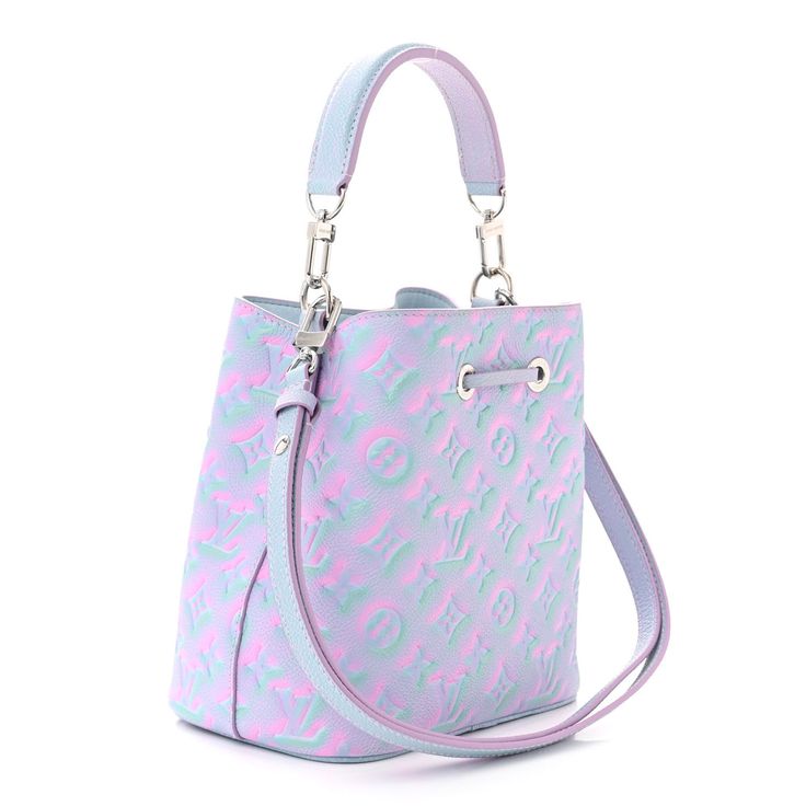 This is an authentic LOUIS VUITTON Empreinte Monogram Summer Stardust Neonoe BB in Lilas. This pre-owned luxury bucket bag is part of the Louis Vuitton Summer 2022 “Summer Stardust” collection. This limited-edition tote is crafted of sprayed Louis Vuitton monogram embossed calf leather in glimmering tones of lila and blue. The bag features an adjustable leather shoulder strap with polished silver hardware and a matching top cinch-cord. This opens the bag to a light blue microfiber interior with a partitioned pocket. The Louis Vuitton Neonoe BB can be carried by hand, in the crook of the arm, over the shoulder with the strap or as a crossbody bag. Louis Vuitton Denim Bag, Louis Vuitton Noe Bag, Louis Vuitton Neonoe, Louis Vuitton Crossbody Bag, Louis Vuitton Crossbody, Louis Vuitton Empreinte, Mini Pouches, Denim Bag, Weekender Tote