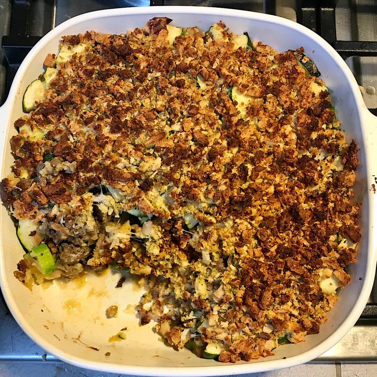 a casserole dish with meat and vegetables in it on top of a stove