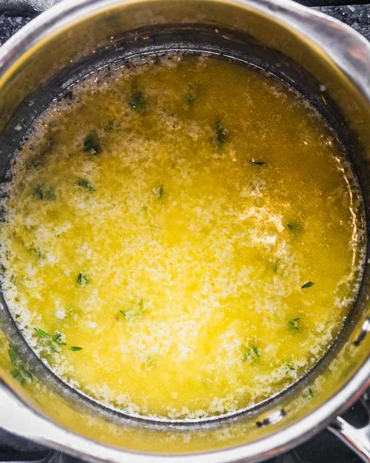 a pot filled with yellow liquid sitting on top of a stove