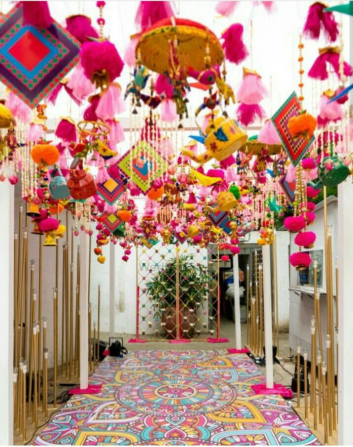 an elaborately decorated hallway with lots of colorful decorations hanging from it's ceiling