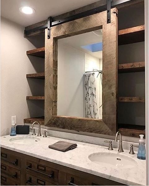 a bathroom with two sinks and a large mirror over the sink in front of it