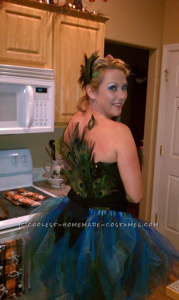 a woman wearing a peacock tutu in a kitchen