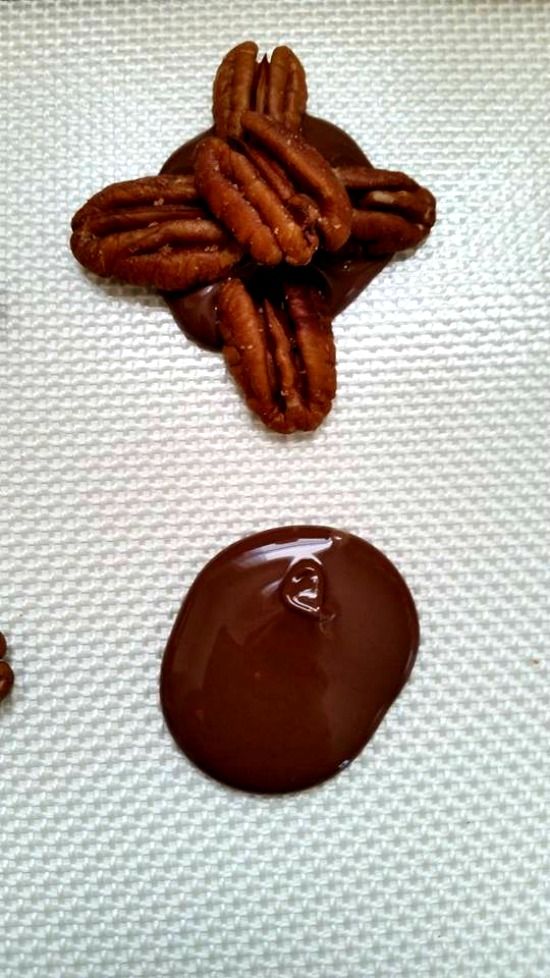 chocolate covered pretzels and cookies on a baking sheet