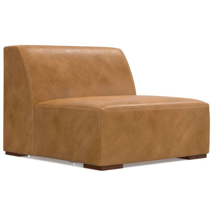 a tan leather chair sitting on top of a white floor