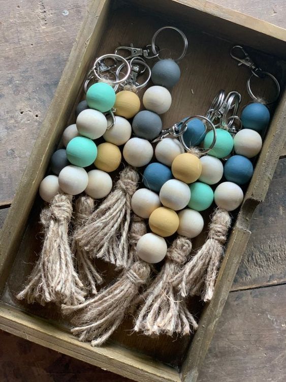 several different colored beads and tassels in a box