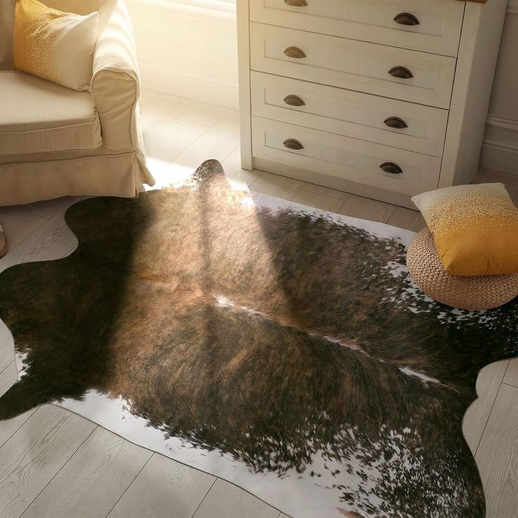 a living room with a chair and a cowhide rug on the floor in front of a window