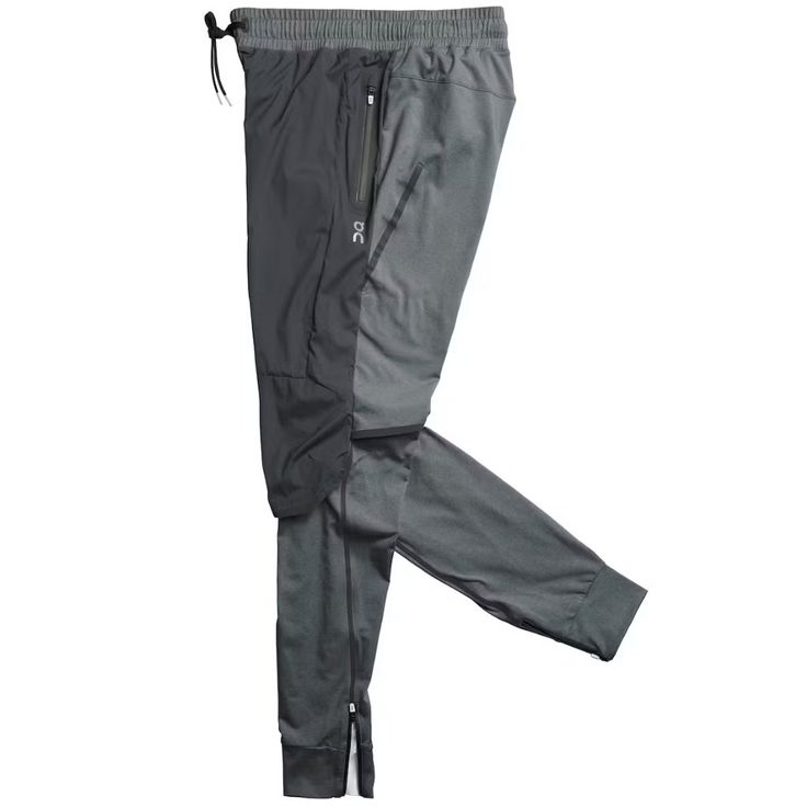 a pair of gray pants with zippers on the side and one leg in front